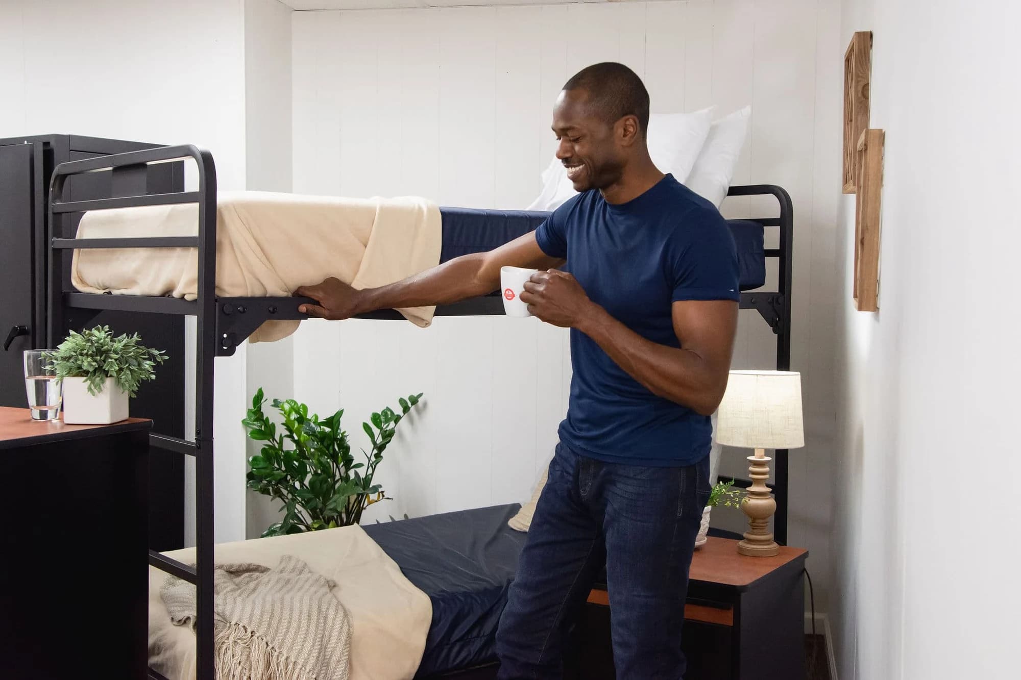 Person demonstrating an American Bedding bunk bed and mattress.